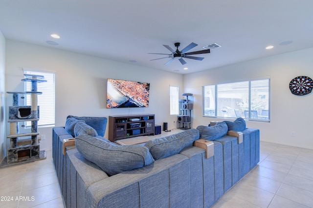 tiled living room featuring ceiling fan and plenty of natural light