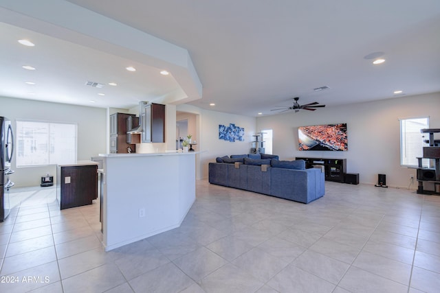 living room with light tile patterned floors and ceiling fan