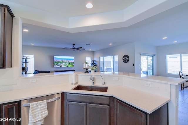 kitchen featuring dishwasher, dark brown cabinetry, sink, and a wealth of natural light