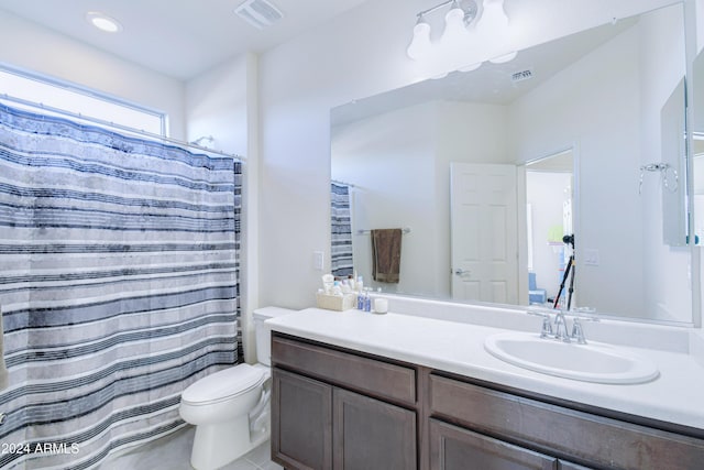 bathroom with tile patterned floors, vanity, and toilet