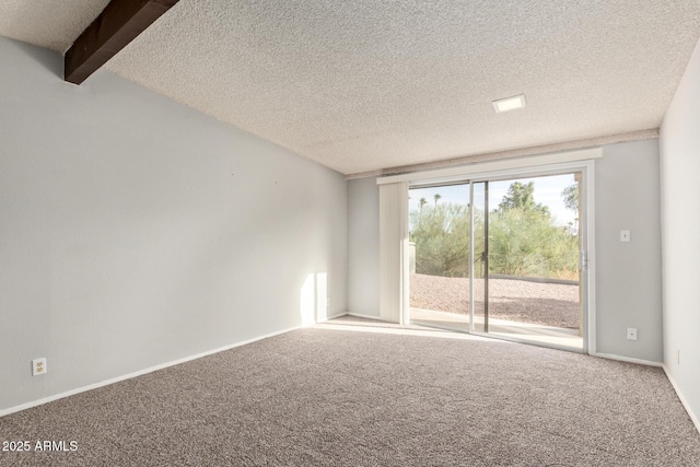 carpeted empty room featuring beam ceiling and a textured ceiling