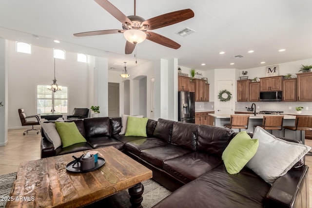 1804 W Magdalena Ln, Phoenix, AZ 85041 - living room with a ceiling fan, a chandelier, recessed lighting, light tile patterned floors, and baseboards