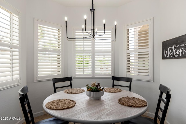 1804 W Magdalena Ln, Phoenix, AZ 85041 - dining room featuring a chandelier, healthy amount of natural light, and baseboards