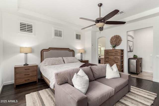 1804 W Magdalena Ln, Phoenix, AZ 85041 - bedroom with baseboards, wood finished floors, arched walkways, a tray ceiling, and a ceiling fan