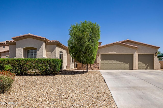 1804 W Magdalena Ln, Phoenix, AZ 85041 - mediterranean / spanish house with stucco siding, a garage, concrete driveway, and a tile roof