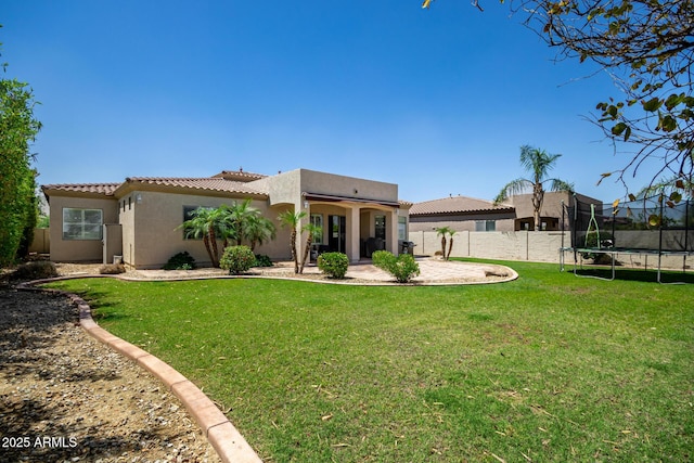 1804 W Magdalena Ln, Phoenix, AZ 85041 - rear view of property with a trampoline, stucco siding, a tiled roof, and a patio