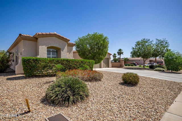 1804 W Magdalena Ln, Phoenix, AZ 85041 - view of front of house with concrete driveway, stucco siding, a tiled roof, and an attached garage