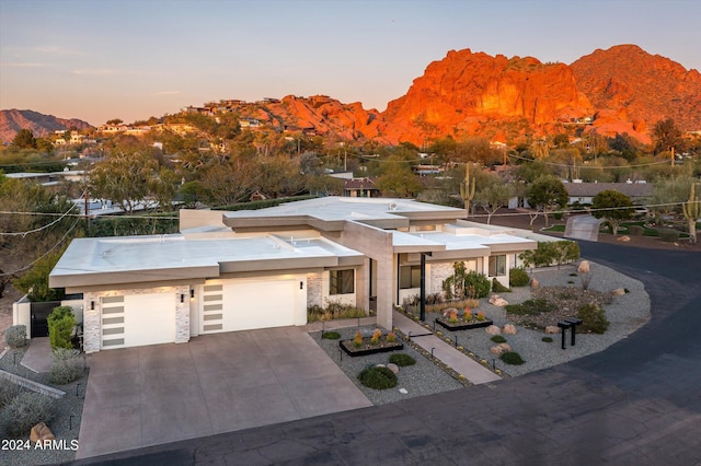 view of front facade featuring a mountain view and a garage