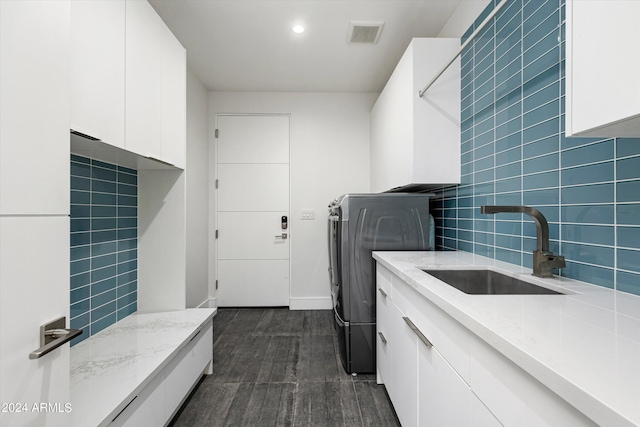 washroom featuring sink and cabinets