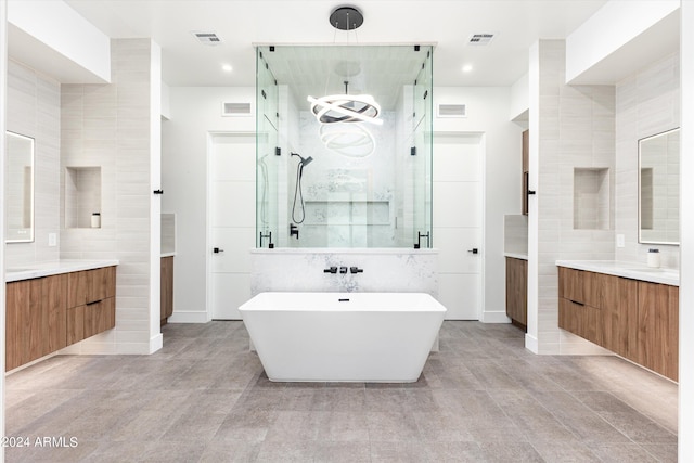 bathroom featuring vanity and separate shower and tub