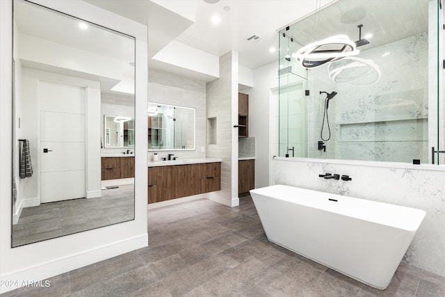 bathroom featuring shower with separate bathtub, tile walls, and vanity