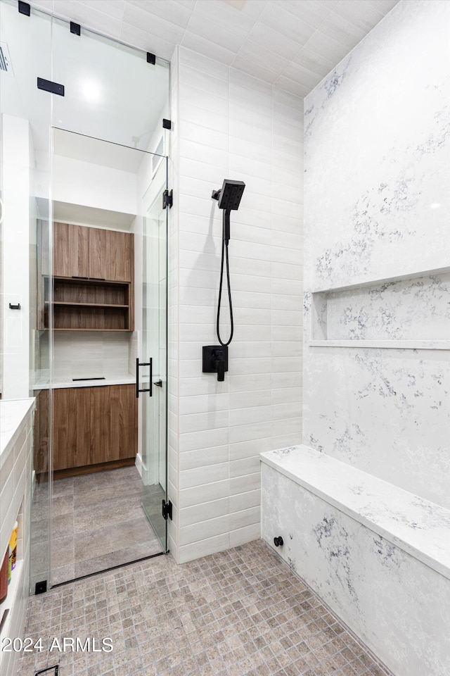 bathroom with a shower with shower door