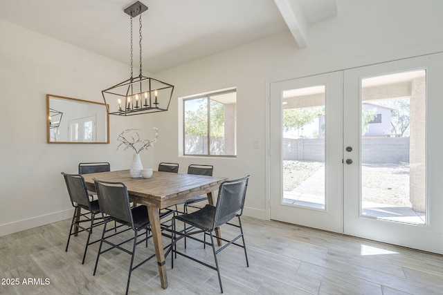 6731 W Northview Ave, Glendale, AZ 85303 - dining space featuring baseboards, french doors, a chandelier, and light wood finished floors