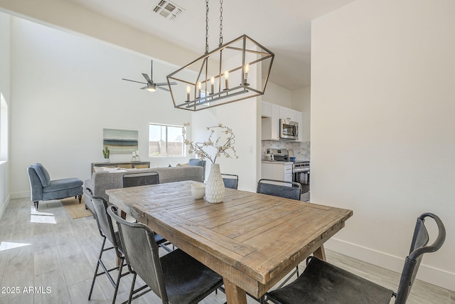 6731 W Northview Ave, Glendale, AZ 85303 - dining space with light wood-type flooring, visible vents, baseboards, and ceiling fan with notable chandelier