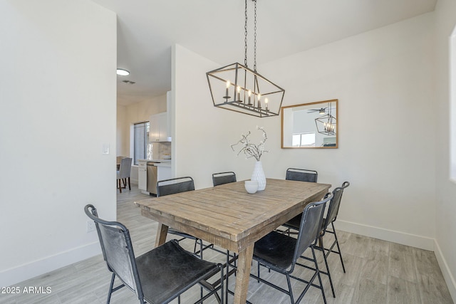 6731 W Northview Ave, Glendale, AZ 85303 - dining space featuring baseboards, an inviting chandelier, visible vents, and light wood-style flooring