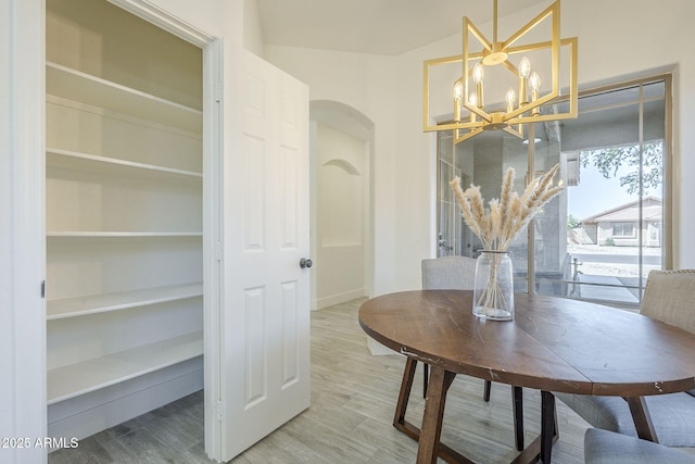 6731 W Northview Ave, Glendale, AZ 85303 - dining room with arched walkways, a notable chandelier, light wood finished floors, and baseboards