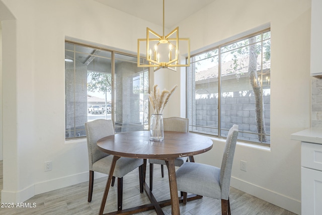 6731 W Northview Ave, Glendale, AZ 85303 - dining room with a wealth of natural light, a chandelier, light wood finished floors, and baseboards
