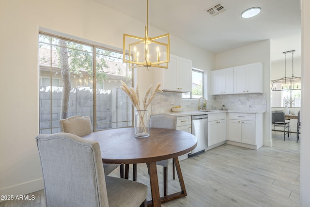 6731 W Northview Ave, Glendale, AZ 85303 - dining room featuring light wood-type flooring, baseboards, visible vents, and a chandelier