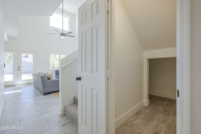 6731 W Northview Ave, Glendale, AZ 85303 - hallway with high vaulted ceiling, french doors, stairs, and light wood finished floors