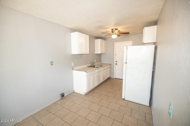 kitchen with white cabinets, sink, ceiling fan, and white fridge