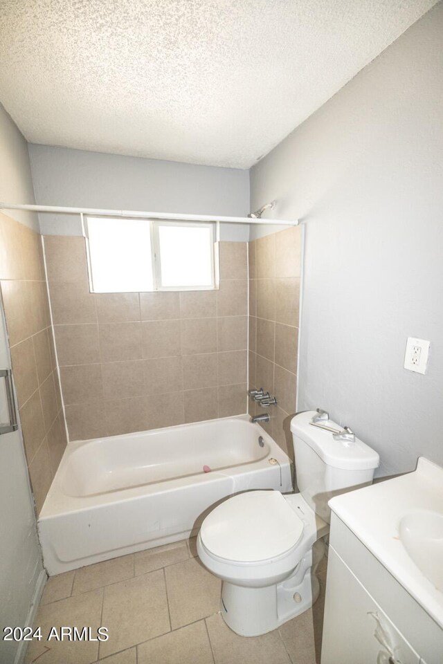 full bathroom featuring tile patterned flooring, vanity, toilet, and tiled shower / bath