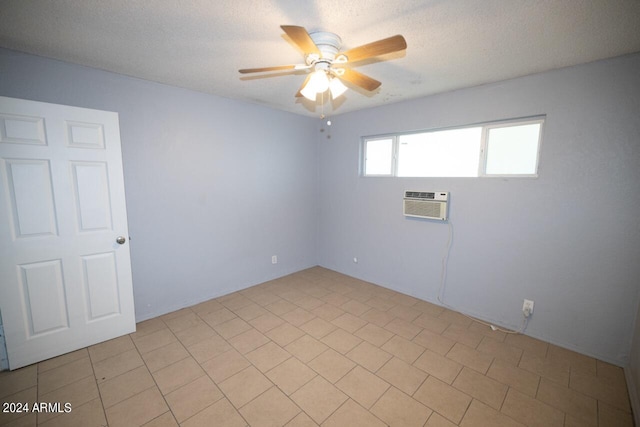 unfurnished room with a textured ceiling, ceiling fan, an AC wall unit, and light tile patterned flooring