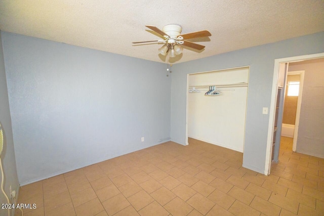 unfurnished bedroom featuring a closet, ceiling fan, and a textured ceiling