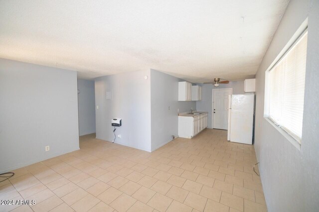 unfurnished living room featuring ceiling fan