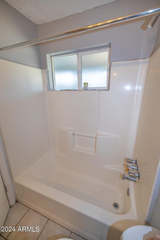 bathroom with plenty of natural light, bathing tub / shower combination, and tile patterned floors