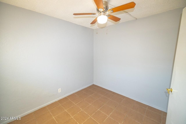 spare room featuring a textured ceiling and ceiling fan