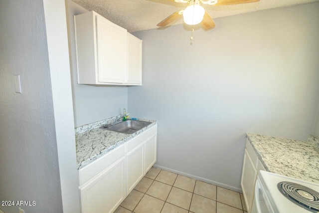 kitchen with white cabinetry, sink, ceiling fan, and a textured ceiling