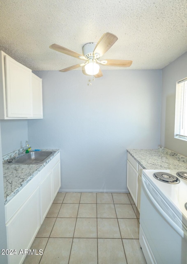 kitchen featuring white cabinetry, ceiling fan, and a textured ceiling