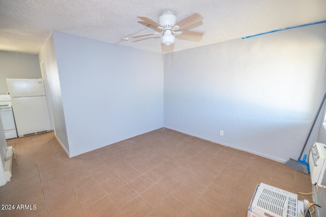 spare room featuring a textured ceiling and ceiling fan