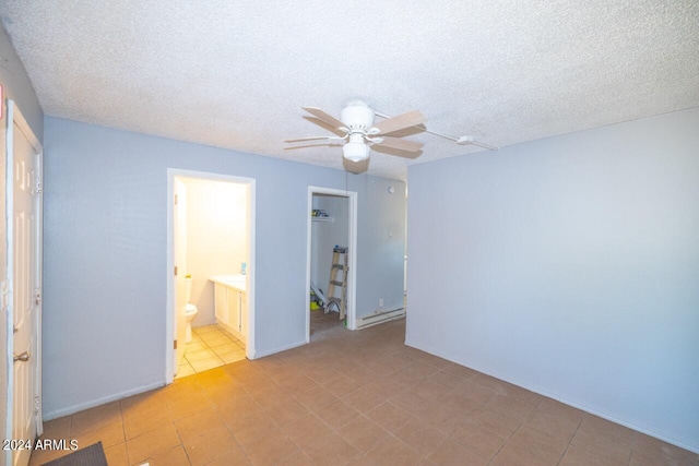 unfurnished bedroom featuring a textured ceiling, ceiling fan, and ensuite bathroom