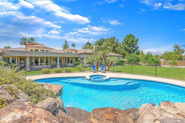 view of pool with a lawn and an in ground hot tub