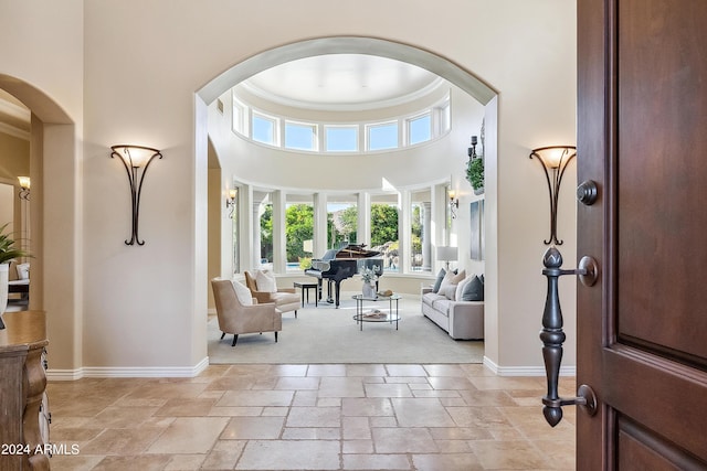 entrance foyer with a towering ceiling and ornamental molding