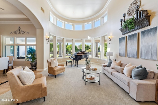 interior space featuring light carpet, a towering ceiling, and ornamental molding