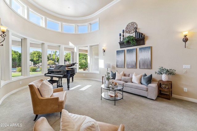 carpeted living room with crown molding and a high ceiling