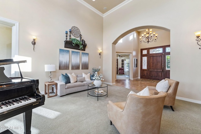 carpeted living room with a chandelier, a high ceiling, and crown molding