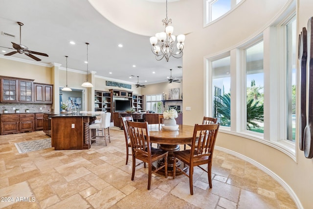 dining area featuring an inviting chandelier, a wealth of natural light, and crown molding