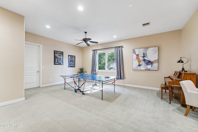 recreation room featuring light colored carpet and ceiling fan