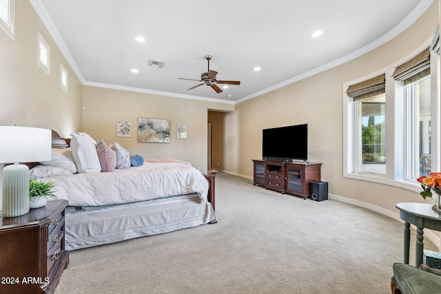 bedroom with ceiling fan, crown molding, and light carpet