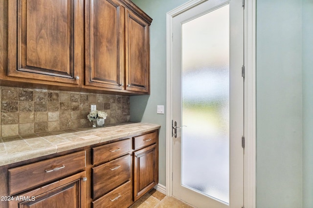 kitchen featuring decorative backsplash and tile counters