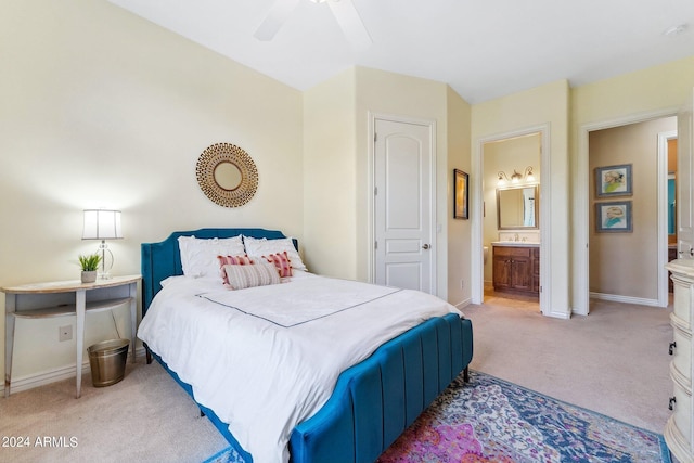 carpeted bedroom featuring ensuite bathroom, sink, and ceiling fan