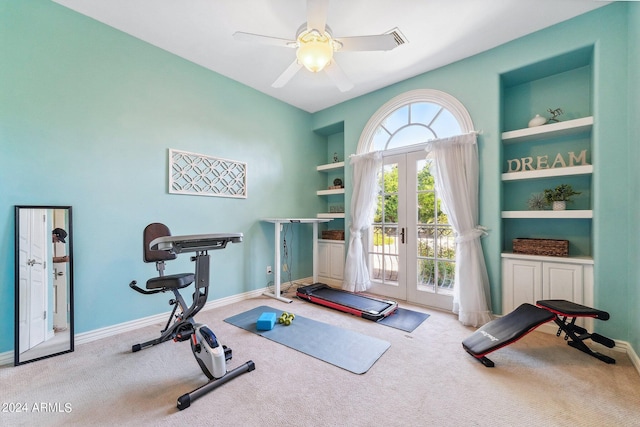 exercise room with built in shelves, ceiling fan, carpet floors, and french doors