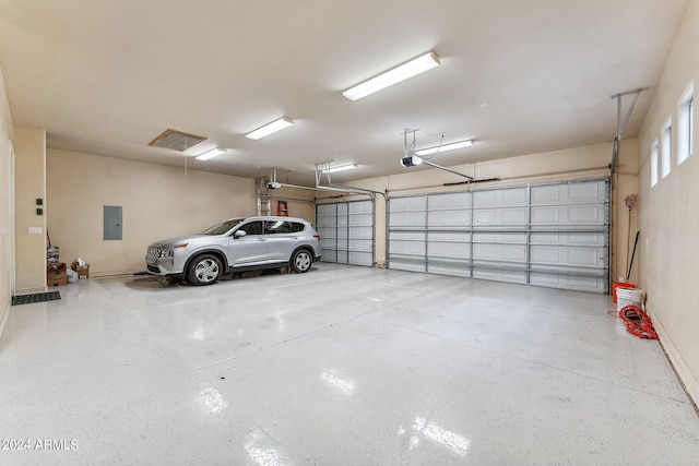 garage featuring a garage door opener and electric panel