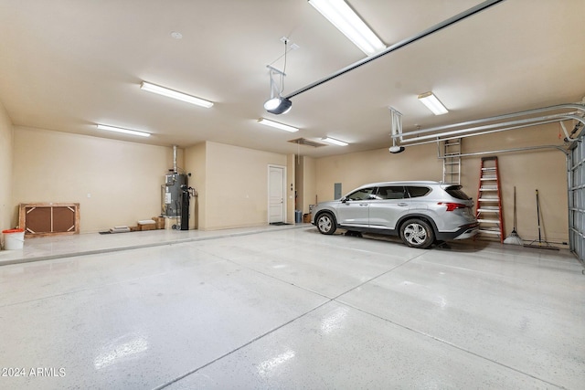 garage featuring a garage door opener and water heater