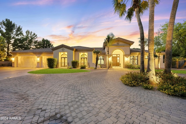 mediterranean / spanish home featuring a garage