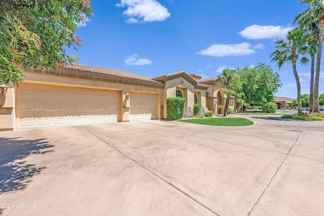 mediterranean / spanish-style house with a garage