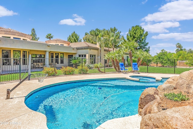 view of pool with an in ground hot tub